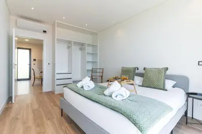 a bedroom with a large bed with towels on it at Sapphire Sands by Atlantic Holiday in Estreito da Calheta