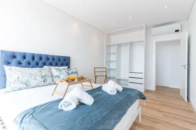 a bedroom with a bed with towels on it at Sapphire Sands by Atlantic Holiday in Estreito da Calheta