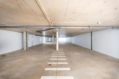 an empty parking garage with white walls and a ceiling at Casa Amado in Carrapateira