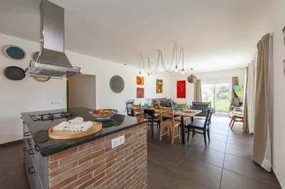 a kitchen and dining room with a table and chairs at D13 - Eiras Velhas Holiday House in Almádena in Almádena