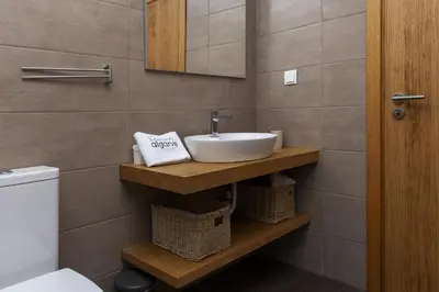 a bathroom with a sink and a toilet at D13 - Eiras Velhas Holiday House in Almádena in Almádena