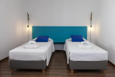 two beds in a room with blue and white at D13 - Eiras Velhas Holiday House in Almádena in Almádena