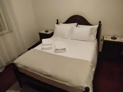 a bedroom with a bed with two books on it at MCR Calheta in Calheta