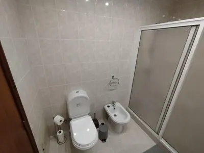 a bathroom with a toilet and a shower and a sink at MCR Calheta in Calheta