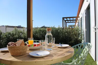 a wooden table with food and a bottle of wine at Casa Amoreira in Carrapateira