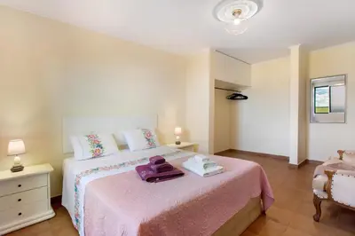 a bedroom with a bed with a pink blanket at Levada Residence in Funchal