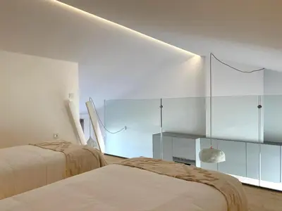 a bedroom with two beds and a glass wall at Casa Arrifana in Carrapateira