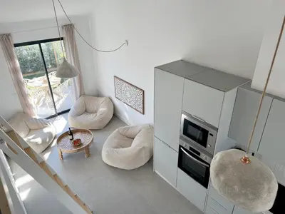 a living room with two chairs and a table at Casa Arrifana in Carrapateira