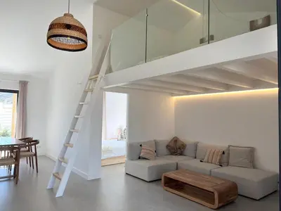 a living room with a couch and a loft bed at Casa Castelejo in Bordeira
