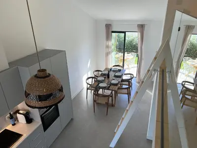 a kitchen and dining room with a table and chairs at Casa Castelejo in Bordeira