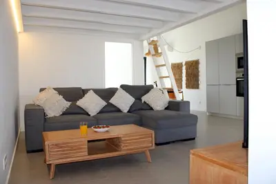 a living room with a couch and a coffee table at Casa Cordoama in Bordeira