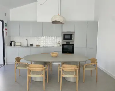 a kitchen with a table and some chairs at Casa Bordeira in Bordeira