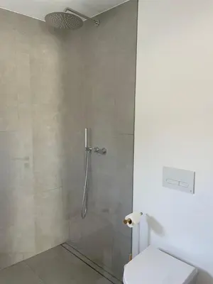 a shower stall with a toilet in a bathroom at Casa Bordeira in Bordeira