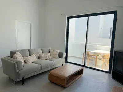 a living room with a couch and a coffee table at Casa Bordeira in Bordeira
