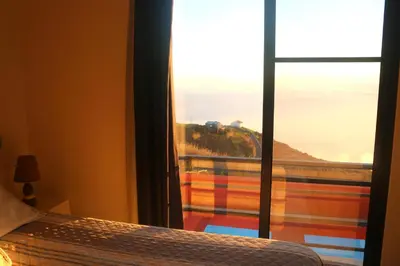 a view of the sun rising above a sea of clouds at Madeira Native Motion Guest House in Fajã da Ovelha