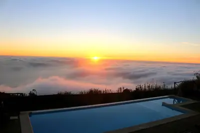 a living room with a couch and a table at Madeira Native Motion Guest House in Fajã da Ovelha