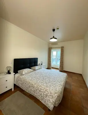 a bedroom with a large bed and a window at Old Zone Apartments 1A in Funchal