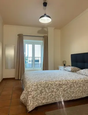 a bedroom with a large bed and a window at Old Zone Apartments 1A in Funchal