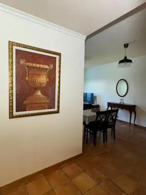 a room with a painting on the wall and a table at Old Zone Apartments 1A in Funchal