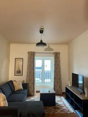 a living room with a couch and a tv at Old Zone Apartments 1A in Funchal