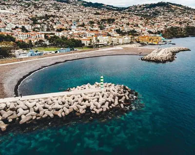 an island in the water with a city in the background at Old Zone Apartments 1A in Funchal