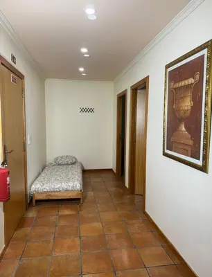 a hallway with a bed and a painting on the wall at Old Zone Apartments 1A in Funchal