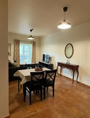 a living room with a table and a mirror at Old Zone Apartments 1A in Funchal