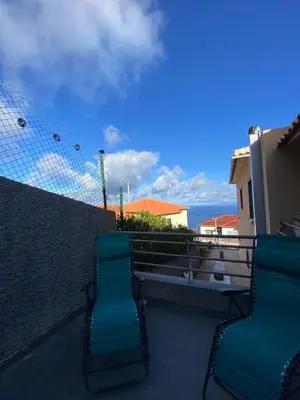 two chairs on a balcony with a view of the ocean at Casa do sol in Santa Cruz