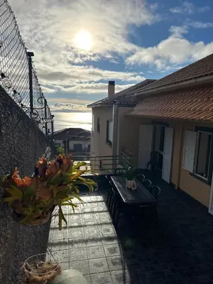 a patio with a table and a bench on a balcony at Casa do sol in Santa Cruz