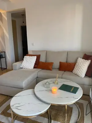 a living room with a couch and two tables at Casa do sol in Santa Cruz