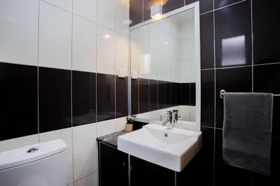 a bathroom with a white sink and a mirror at Machico Oasis in Machico