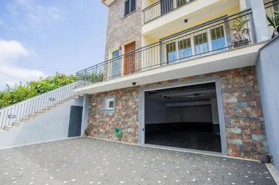 a garage in a building with a balcony at Machico Oasis in Machico