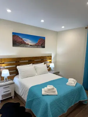 a bedroom with a bed with two towels on it at Vila Romana in São Vicente