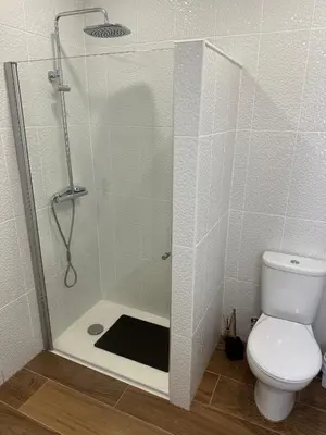 a shower stall with a toilet in a bathroom at Vila Romana in São Vicente