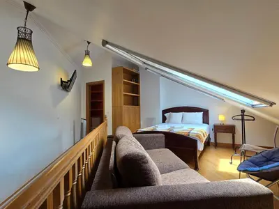a bedroom with a bed and two chairs in a room at Penthouse in the center of Funchal in Funchal