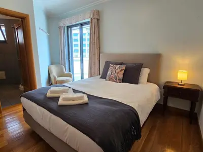 a bedroom with a bed with two towels on it at Penthouse in the center of Funchal in Funchal