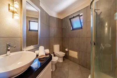 a bathroom with a sink and a toilet and a shower at Penthouse in the center of Funchal in Funchal