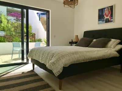 a bedroom with a bed and a sliding glass door at Casa Turquesa in Salema