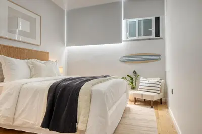 a bedroom with a large bed and a chair at Seashell, a Home in Madeira in Machico