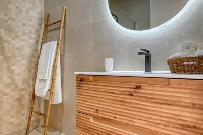 a bathroom with a sink and a mirror at Seashell, a Home in Madeira in Machico