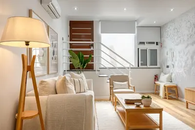a living room with a couch and a table at Seashell, a Home in Madeira in Machico