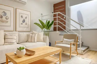 a living room with a couch and a table at Seashell, a Home in Madeira in Machico