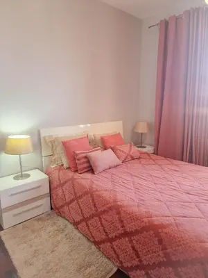 a bedroom with a bed with a red blanket and pillows at Basilio's Villa in Funchal