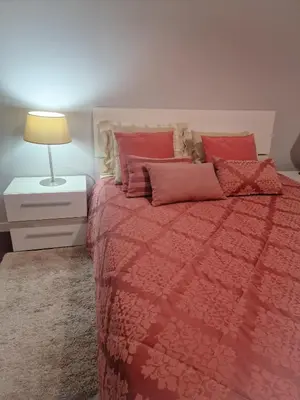 a bedroom with a bed with a red blanket and a lamp at Basilio's Villa in Funchal