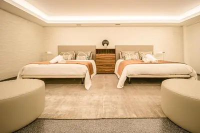 a white bed in a room with a large window at Villa Bela in Funchal