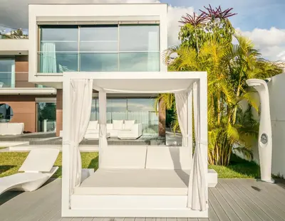 a white house with a swing on a deck at Villa Bela in Funchal