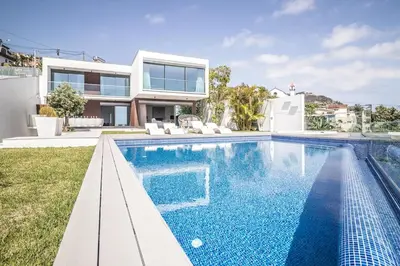a living room with a white couch and a table at Villa Bela in Funchal