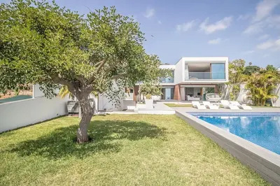 a house with a view of the ocean and a pool at Villa Bela in Funchal