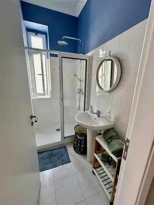 a bathroom with a sink and a shower and a mirror at Apartment Minorca in Funchal
