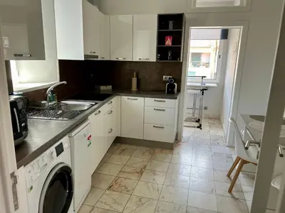 a kitchen with white cabinets and a sink and a dishwasher at Apartment Minorca in Funchal